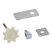 A group of metal parts including a silver rectangular hasp with holes and a white rectangular gear.