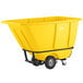 A yellow plastic container on black wheels.