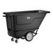 A black heavy-duty tilt truck or trash cart with a 0.5 cubic yard capacity and large wheels, designed for transporting heavy loads.