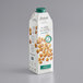 A carton of Elmhurst Unsweetened Milked Walnuts on a white surface.