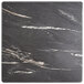 A close-up of a Lancaster Table & Seating black and white marble square table top.