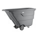 A large gray tilt truck or trash cart with wheels, designed for heavy-duty waste transport.