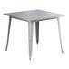 A nickel gray metal square table with legs.