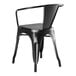 A Lancaster Table & Seating black metal outdoor arm chair with a back and armrests.