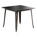 A Lancaster Table & Seating distressed copper square table with black metal legs.