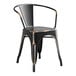 A black metal Lancaster Table & Seating outdoor arm chair with a black seat.