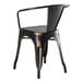 A black metal Lancaster Table & Seating outdoor arm chair with a black seat and back.