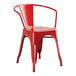 A Lancaster Table & Seating red metal outdoor arm chair.