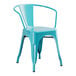 A turquoise metal Lancaster Table & Seating outdoor arm chair.