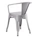 A Lancaster Table & Seating Alloy Series nickel gray outdoor arm chair with armrests and a white back.