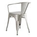 A Lancaster Table & Seating silver metal arm chair with a backrest.