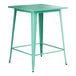 A Lancaster Table & Seating aquamarine metal bar height table with a square top and legs.