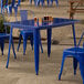 A blue table and chairs on a patio.