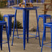 A Lancaster Table & Seating blue quartz bar height table with blue metal chairs.