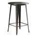 A black metal bar table with a distressed copper top.