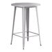 A Lancaster Table & Seating nickel gray metal table with a round top and legs.