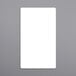 a white rectangular object on a gray surface