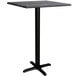 A black Lancaster Table & Seating bar height table with a black base.