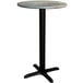 A Lancaster Table & Seating round table with a black base and a textured green top.