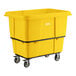 A large yellow leakproof cube truck with a 16 cubic foot capacity and four caster wheels.