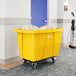 A large yellow Lavex cube truck with an 8 cubic foot capacity, designed for transporting laundry or materials.