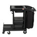A Suncast black housekeeping cart with a bag on it.
