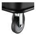 A close-up of a caster wheel attached to a black Lavex 8 cubic foot cube truck.