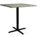 A Lancaster Table & Seating square table with a textured canyon metal surface and a cross base plate.