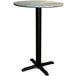 A Lancaster Table & Seating round table with a textured canyon metal top and cross base plate.