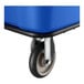 A close-up of a blue Lavex 16 cubic foot leakproof cube truck with a caster wheel.
