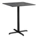 A square bar height table with a smooth dark finish and a black cross base plate.