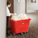 A woman putting a bag in a red Lavex cube truck.