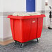 A large red Lavex cube truck with a 12 cubic foot capacity, designed for transporting laundry or materials.