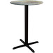 A Lancaster Table & Seating Excalibur round bar height table with a textured canyon metal top and black cross base plate.