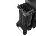 A black Suncast divided bag on a cart above a black Rubbermaid trash can.