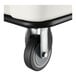 A close-up of a caster wheel attached to the bottom of a white Lavex 8 cubic foot cube truck.