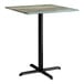 A square bar height table with a textured faux metal finish top and a black cross base plate.