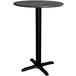 A Lancaster Table & Seating round counter height table with a black base.