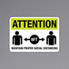 A black and yellow aluminum sign that says "Attention / Maintain Proper Social Distancing" with images.