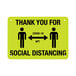 A yellow and black aluminum sign with text reading "Thank You For Social Distancing" and a black figure on a yellow background.