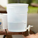 A person using a clear round Choice hand washing dispenser.