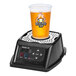 A ReverseTap beer dispenser with a cup on top.