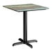 A square standard height table with a textured faux metal finish top and a black cross base plate.