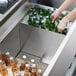 A Regency beer box divider in a cooler separating bottles of beer.