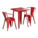 A red Lancaster Table & Seating outdoor table and two arm chairs.