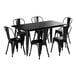 A black rectangular Lancaster Table & Seating outdoor table with six chairs.