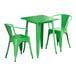 A Lancaster Table & Seating Jade Green Table with 2 Arm Chairs on an outdoor patio.