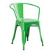A jade green metal chair with arms and a back.