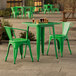 A jade green Lancaster Table & Seating outdoor table with chairs on a stone patio.