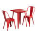 A Lancaster Table & Seating ruby red metal table and chairs set.